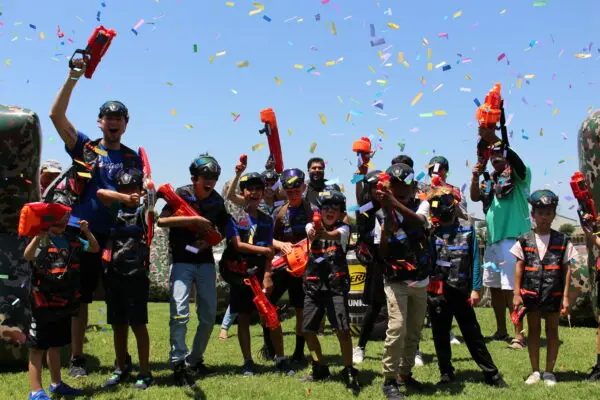 Party guests celebrating with Nerf blasters