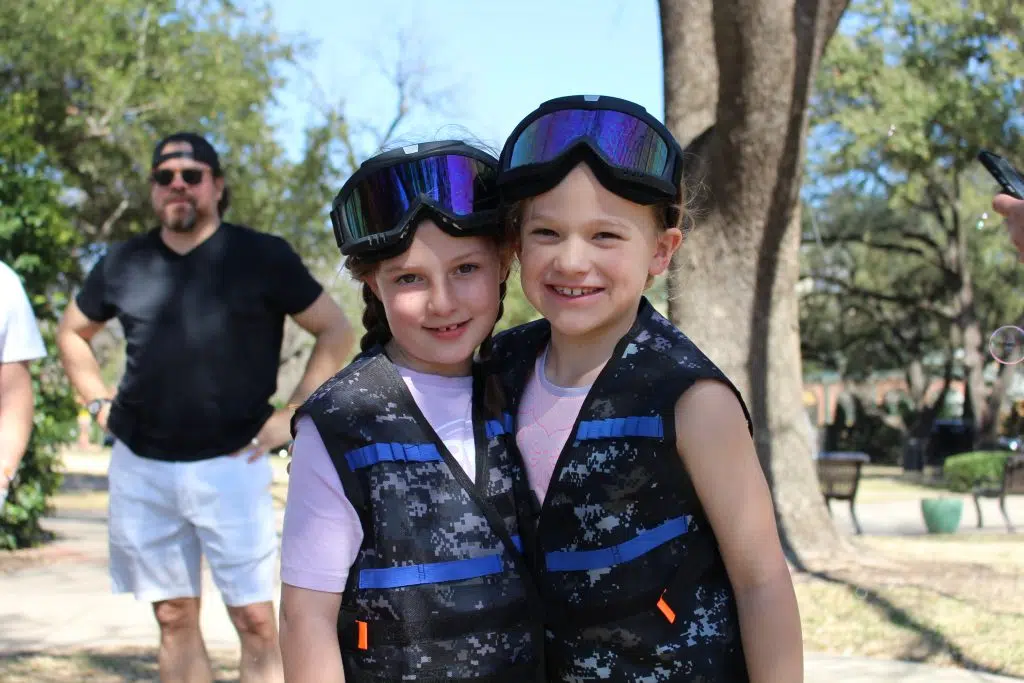 Two smiling children sharing a moment at a 4 Knight Wars party