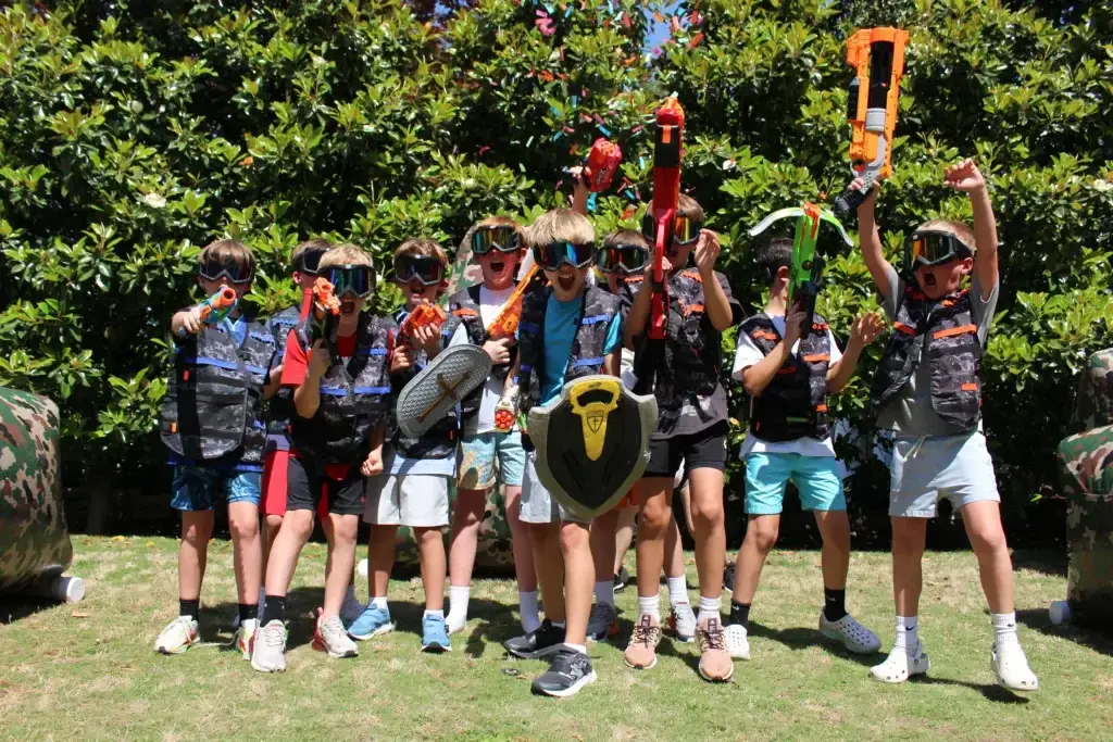 Party guests celebrating a 4 Knight Wars Nerf battle
